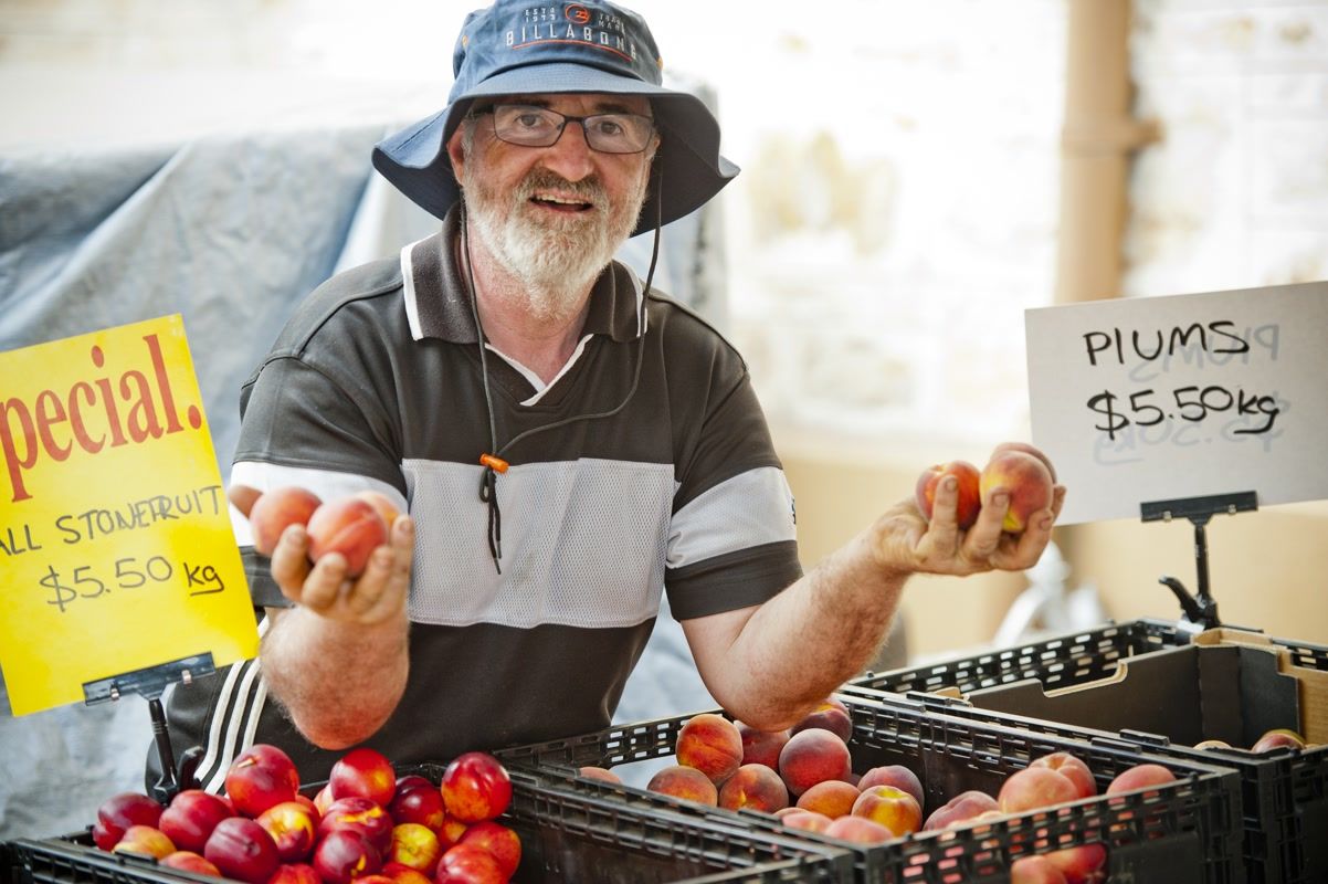 Man selling plums