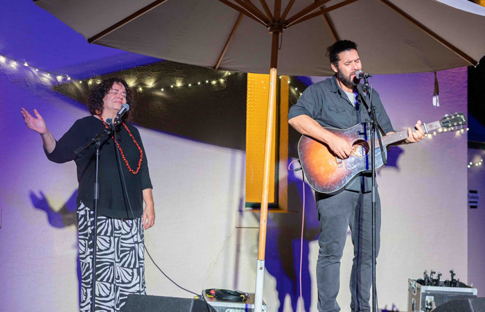 REKINDLE Flaxley Woven committee leader and event co-convener Aunty Ros Cameron performing with singer-songwriter Tim Moore