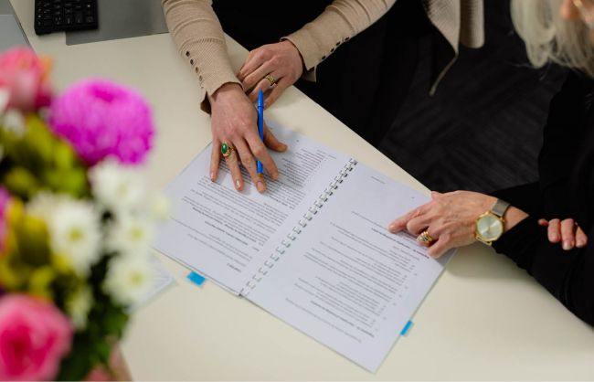 Women looking at document on desk